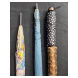 Group of Assorted Vintage and Patterned Umbrellas with Wooden Handles Group of Assorted Vintage and Patterned Umbrellas with Wooden Handles