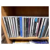 Collection of Music CDs on Wood Bookshelf (inc) Collection of Music CDs on Wood Bookshelf (inc)