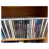 Collection of Music CDs on Wood Bookshelf (inc) Collection of Music CDs on Wood Bookshelf (inc)