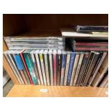 Collection of Music CDs on Wood Bookshelf (inc) Collection of Music CDs on Wood Bookshelf (inc)