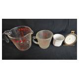 Kitchenware Lot with Pyrex Measuring Cups, Ceramic Ramekin, and Tylor Oven Thermometer Kitchenware Lot with Pyrex Measuring Cups, Ceramic Ramekin, and Tylor Oven Thermometer