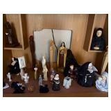 Collection of Religious Figurines and Statues Featuring Nuns and Saints