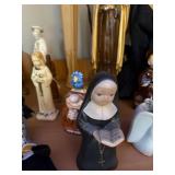 Collection of Religious Figurines and Statues Featuring Nuns and Saints