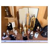 Collection of Religious Figurines and Statues Featuring Nuns and Saints