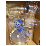 Collection of Glass Drinkware and Serving Pieces Including Mugs, Beer Pitcher, and Apple Dish