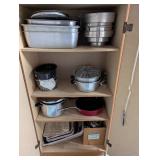 Tall Oak-Look Kitchen Storage Cabinet with Assorted Cookware and Bakeware