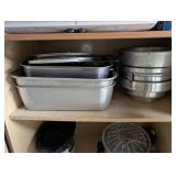 Tall Oak-Look Kitchen Storage Cabinet with Assorted Cookware and Bakeware