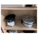 Tall Oak-Look Kitchen Storage Cabinet with Assorted Cookware and Bakeware