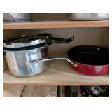 Tall Oak-Look Kitchen Storage Cabinet with Assorted Cookware and Bakeware