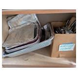 Tall Oak-Look Kitchen Storage Cabinet with Assorted Cookware and Bakeware