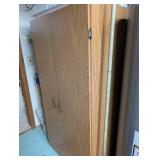 Tall Oak-Look Kitchen Storage Cabinet with Assorted Cookware and Bakeware