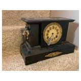 Antique Black Mantel Clock with Ornate Lion Head Details