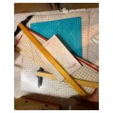 Collection of Quilting Mats, Gridded Rulers, and Cutting Tools