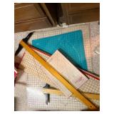 Collection of Quilting Mats, Gridded Rulers, and Cutting Tools