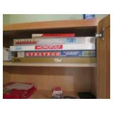 Oak cabinet filled with games and c... Oak cabinet filled with games and c...