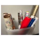 Assorted Gift Wrap and Wrapping Paper Rolls in Plastic Bin