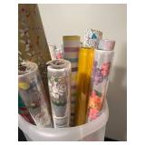 Assorted Gift Wrap and Wrapping Paper Rolls in Plastic Bin