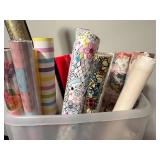 Assorted Gift Wrap and Wrapping Paper Rolls in Plastic Bin