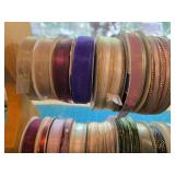 Collection of Assorted Decorative Ribbon Spools with Wooden Rack