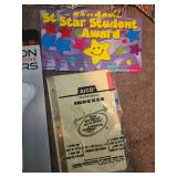 Assorted Office and School Supplies Collection with Scissors, Pens, Laminating Sheets, and Awards