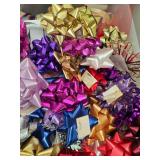 Collection of Gift Wrap Supplies with Rolls, Bows, Ribbons, and Decorative Pieces