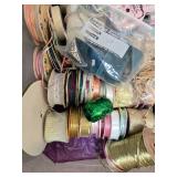 Collection of Gift Wrap Supplies with Rolls, Bows, Ribbons, and Decorative Pieces
