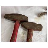 Two Hammers and Two Pry Bars with Red Handles and Rust Patina Two Hammers and Two Pry Bars with Red Handles and Rust Patina