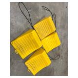 Four Yellow Plastic Wheel Chocks with Attached Ropes Four Yellow Plastic Wheel Chocks with Attached Ropes