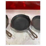 Four Assorted Cast Iron Skillets Including Wagner and Griswold Four Assorted Cast Iron Skillets Including Wagner and Griswold