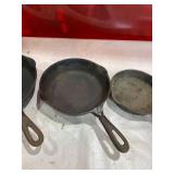 Four Assorted Cast Iron Skillets Including Wagner and Griswold Four Assorted Cast Iron Skillets Including Wagner and Griswold
