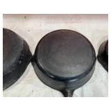 Four Assorted Cast Iron Skillets Including Wagner and Griswold Four Assorted Cast Iron Skillets Including Wagner and Griswold