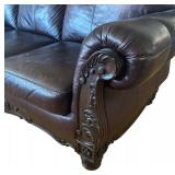 Elegant Leather Sofa with Carved Wood Accents