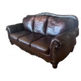 Elegant Leather Sofa with Carved Wood Accents