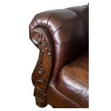 Elegant Leather Sofa with Carved Wood Accents