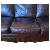 Elegant Leather Sofa with Carved Wood Accents