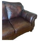 Elegant Leather Sofa with Carved Wood Accents
