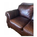 Elegant Leather Sofa with Carved Wood Accents