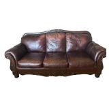 Elegant Leather Sofa with Carved Wood Accents