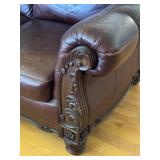 Elegant Leather Sofa with Carved Wood Accents