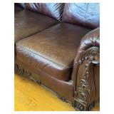Elegant Leather Sofa with Carved Wood Accents