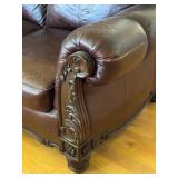 Elegant Leather Sofa with Carved Wood Accents