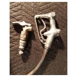 Vintage gasoline pump nozzle and a barrel tap Vintage gasoline pump nozzle and a barrel tap