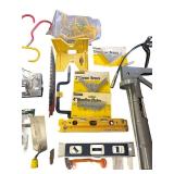 Assorted Hand Tools and Hardware Collection with Levels, Saws, Brackets, and Caulking Guns
