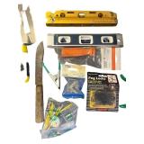 Assorted Hand Tools and Hardware Collection with Levels, Saws, Brackets, and Caulking Guns