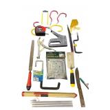 Assorted Hand Tools and Hardware Collection with Levels, Saws, Brackets, and Caulking Guns