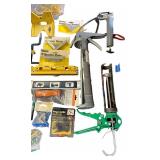 Assorted Hand Tools and Hardware Collection with Levels, Saws, Brackets, and Caulking Guns