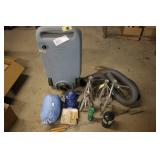 Garage and Camping Utility Lot with Jack Stands, Blue Jug, Sleeping Bag, and Tools