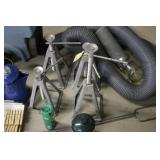 Garage and Camping Utility Lot with Jack Stands, Blue Jug, Sleeping Bag, and Tools