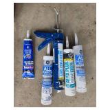 Assorted Plumbing Supplies with Caulk, Sealants, and Tools Assorted Plumbing Supplies with Caulk, Sealants, and Tools