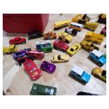 A SMALL COOLER FILLED WITH TOY CARS AND HEAVY EQUIPMENT RIGS A SMALL COOLER FILLED WITH TOY CARS AND HEAVY EQUIPMENT RIGS
